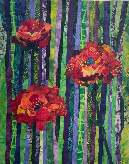 Colorful floral artwork with green and purple vertical striped pattern  made with layered fabric featuring opening blossoms in reds and oranges