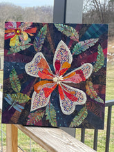 Colorful flowers and dragonfly on a wooden surface with a deeply tonal background