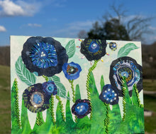 Floral artwork made with layered fabric and mixed media, featuring clustered blooms and layered textured composition