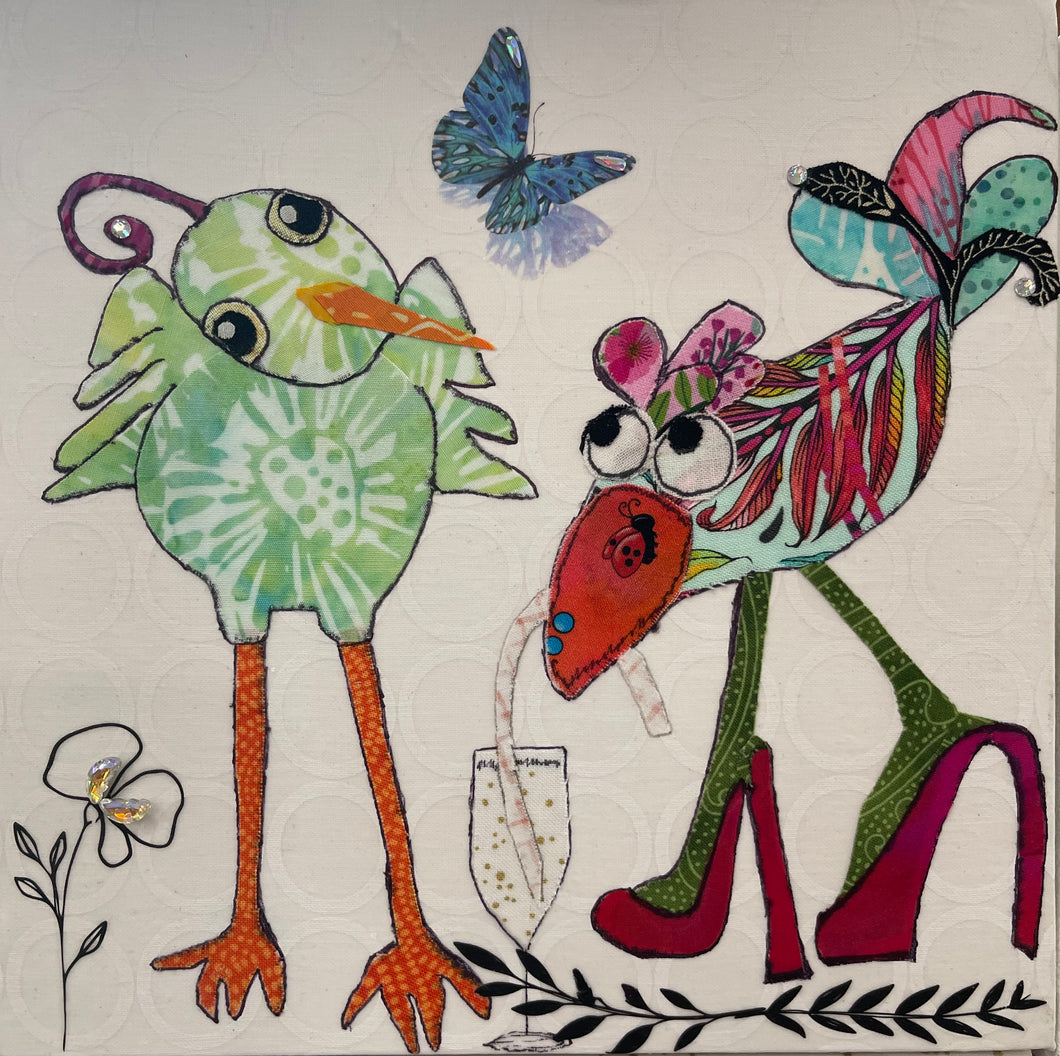 Whimsical bird artwork made with layered fabric and mixed media, featuring playful birds in greens with feather looking details and red high heel shoes drinking from a champagne glass on soft neutral background