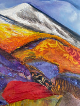 Close up Abstract landscape painting with colorful  orange, purple and red layers and a white capped mountain layered on a blue sky.