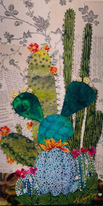 Original saguaro cactus fabric artwork 6x12 inches, tall saguaro in deep green fabric with prickly pear and pad cacti in chartreuse teal blue polka dot batik Swarovski crystal flowers scattered blooms ink pen spine detail, vintage toile botanical text background warm brown ground, birch panel, Floral Botanical Collection, Robyn Moore Arts