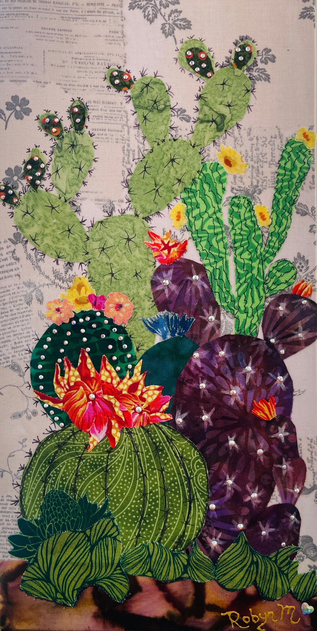 Original flowering cactus fabric artwork 6x12 inches, tall columnar green cacti dramatic dark spotted cactus with vivid pink orange blooms purple prickly pear Swarovski crystals ink pen spine detail, vintage toile botanical text background warm brown ground, birch panel, Floral Botanical Collection, Robyn Moore Arts