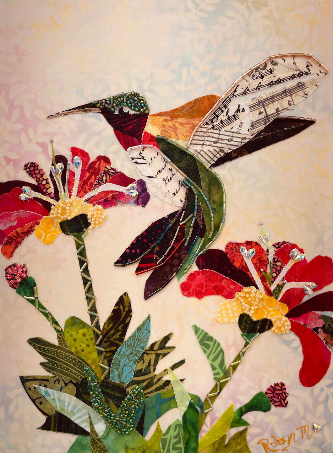 Original hummingbird fabric artwork 9x12 inches, ruby throated hummingbird in layered crimson teal gold batik fabric Czech glass bead head sheet music printed fabric wings Swarovski crystal flower centers lush green foliage, cream blush blue batik background, birch panel, Floral Botanical Whimsical Companions Collections, Robyn Moore Arts