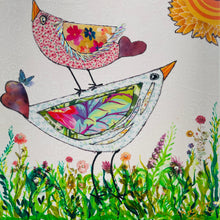 Whimsical bird artwork made with layered fabric and mixed media, featuring uplifting bird forms in soft neutral and warm tones in a grassy flower field