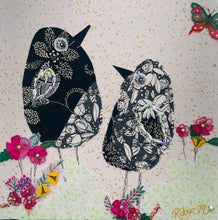 Textile bird art showing two black and white patterned birds surrounded by soft florals in a calm, minimalist composition