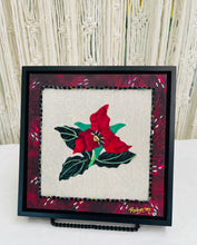 8 x 8 fabric collage artwork featuring a deep red flower with a gold heart center and green beaded leaves made from inherited textiles