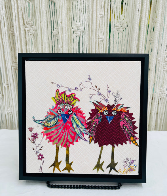 Whimsical bird textile art with two colorful patterned birds standing together on a soft neutral background