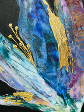 Close-up of abstract art piece with gold, blue, and purple colors on a black background