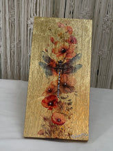 Gold leaf wood panel titled Solace featuring a dark-winged dragonfly over red and coral poppies, hand-signed by the artist, 6x12 inches.