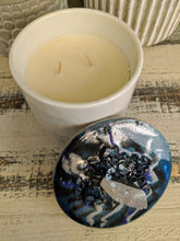 white and grey canister with blue lid and crystal stone