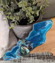 close up bamboo resin north carolina cheeseboard in teals with shells
