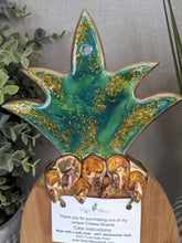 close up bamboo pineapple cheese board with resin and shells