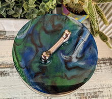 clear glass dog treat canister with wood lid coated in blue green white bronze resin with silver bone