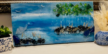 “Small coastal artwork made with recycled glass and resin, featuring soft blue tones and light-reflective texture”