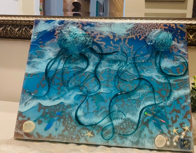 Blue jellyfish coastal wall art in glass and epoxy resin with flowing tentacles, ocean textures, and dimensional detail