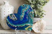 abstract blue green heart with stones