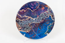 abstract fluid acrylic resin painting with vibrant blue deep magenta and gold colors with stones