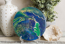 abstract fluid resin trivet with vibrant blue green gold colors